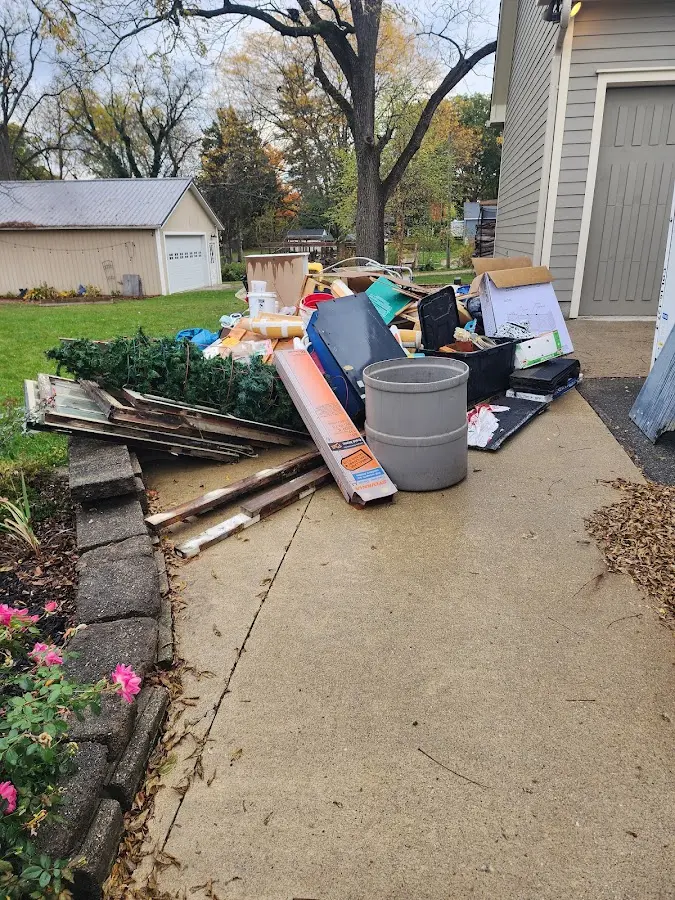 Dumpster being loaded with debris for 3 Yard Dumpster Rental in Novi